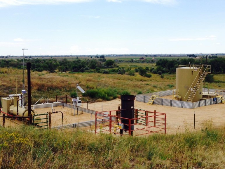 An oil and gas site near the St. Vrain Creek. Metal berms replace earthen ones.