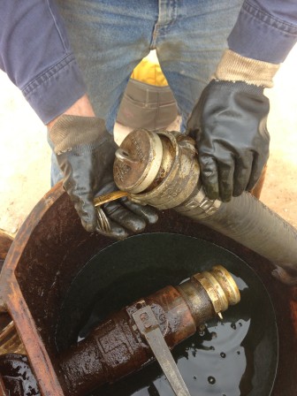 A worker transfers crude oil from a truck to a pipeline that sends the oil to several states. The FBI says a recent case involving stolen oil has set a precedent.