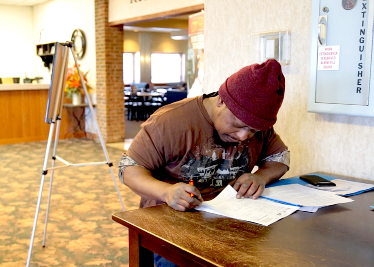 A job seeker fills out an application at the oilfield job fair in Williston, North Dakota on March 11, 2015.