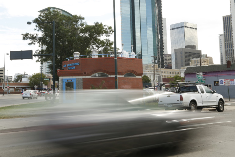 A car whizzes past an air monitoring station in downtown Denver, CO. Sites like these around the country measure levels of ground-level ozone and other pollutants