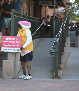 People dressed as pencils urge Colorado voters to 'decline to sign.'
